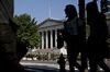 Pedestrians walk near the U.S. Treasury building in Washington, D.C., U.S., on Monday, July 16, 2018. The House this week plans to consider a minibus spending bill that combines legislation funding the Treasury, Internal Revenue Service (IRS), and the Securities and Exchange Commission (SEC) with another bill keeping the Interior Department and Environmental Protection Agency (EPA) running.