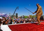 Omar al-Bashir performs with his cane as he addresses a rally of his supporters in Khartoum on Jan. 9.