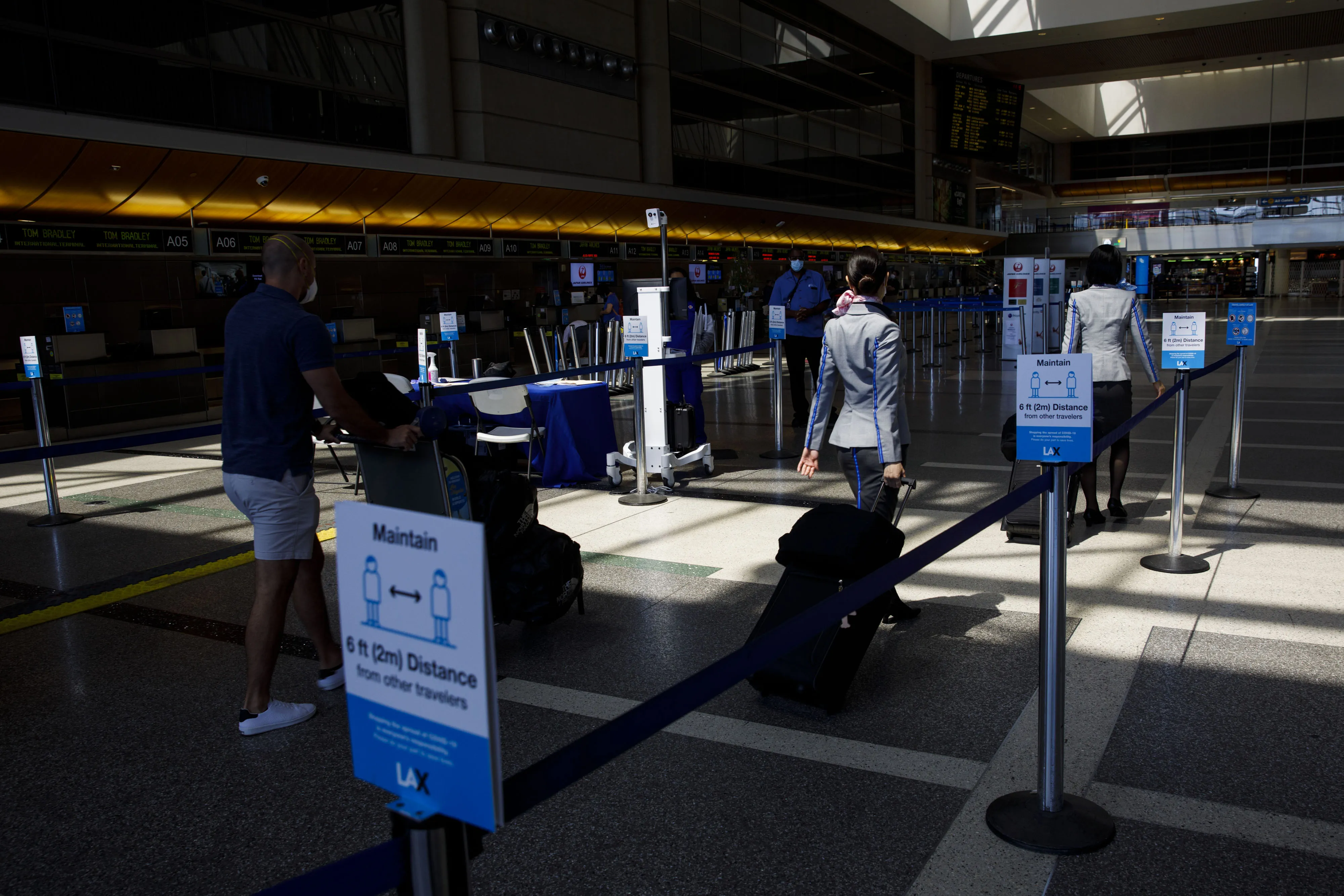 Passengers walk past thermal imaging cameras at Los Angeles International Airport.