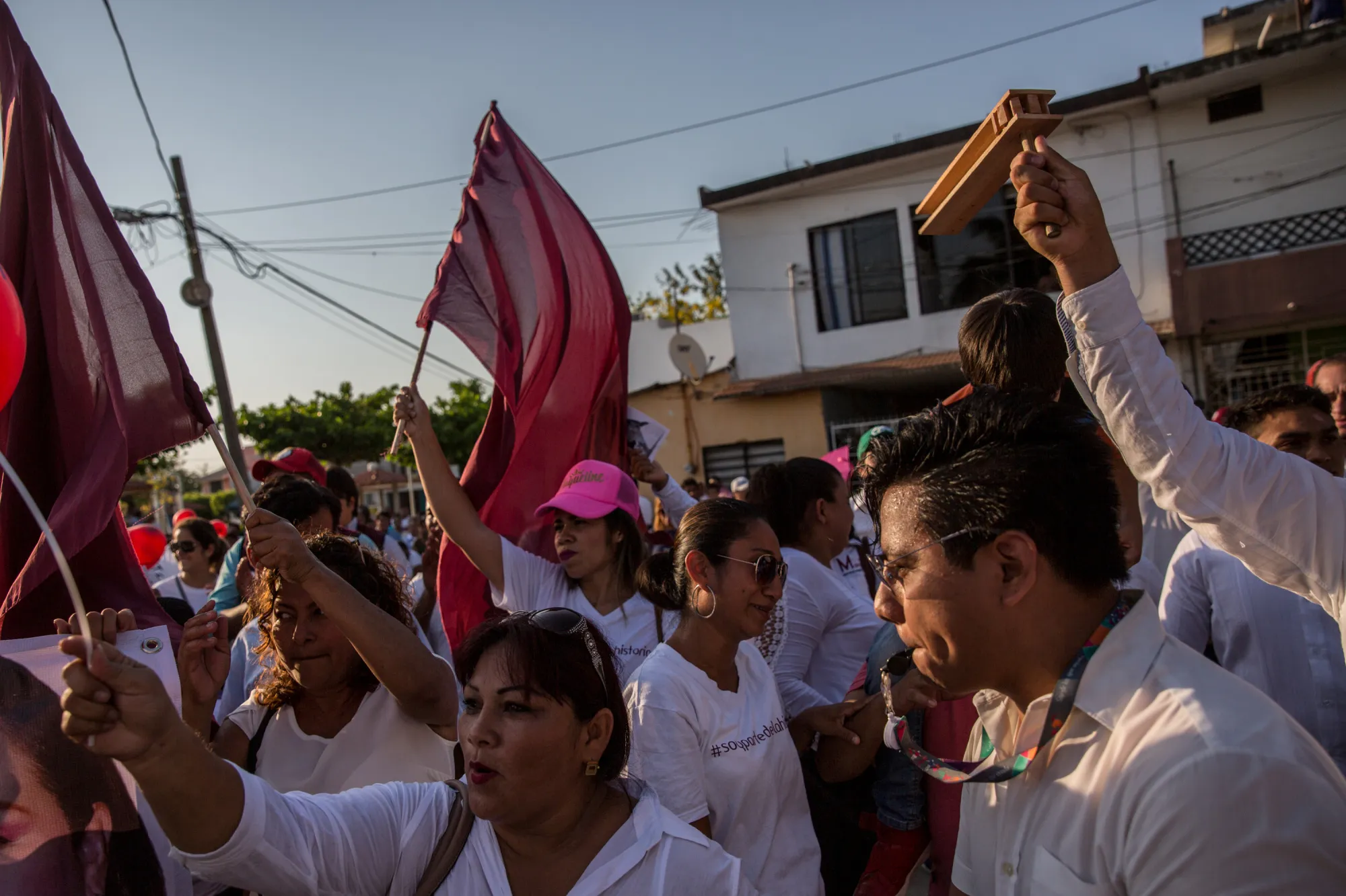 People wave flags during a political rally for the MORENA party in Villahermosa, Mexico, on April 18, 2018.