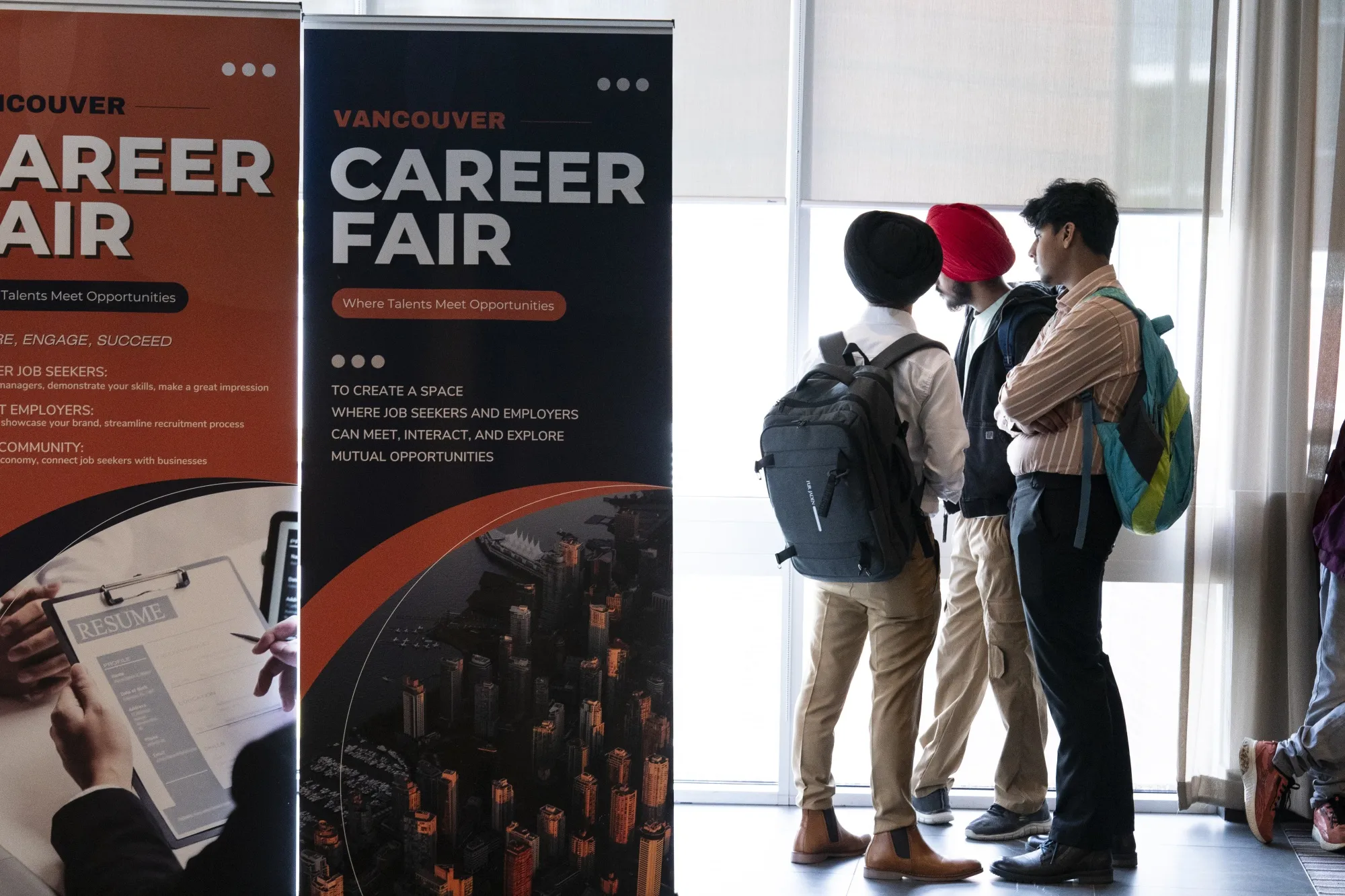 Attendees wait for a career fair to begin in Burnaby, British Columbia, on June 24.