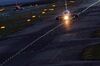 A passenger aircraft taxies on a runway at night at the Kansai International Airport in Izumisano City, Osaka, Japan.
