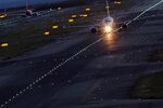 A passenger aircraft taxies on a runway at night at the Kansai International Airport in Izumisano City, Osaka, Japan.