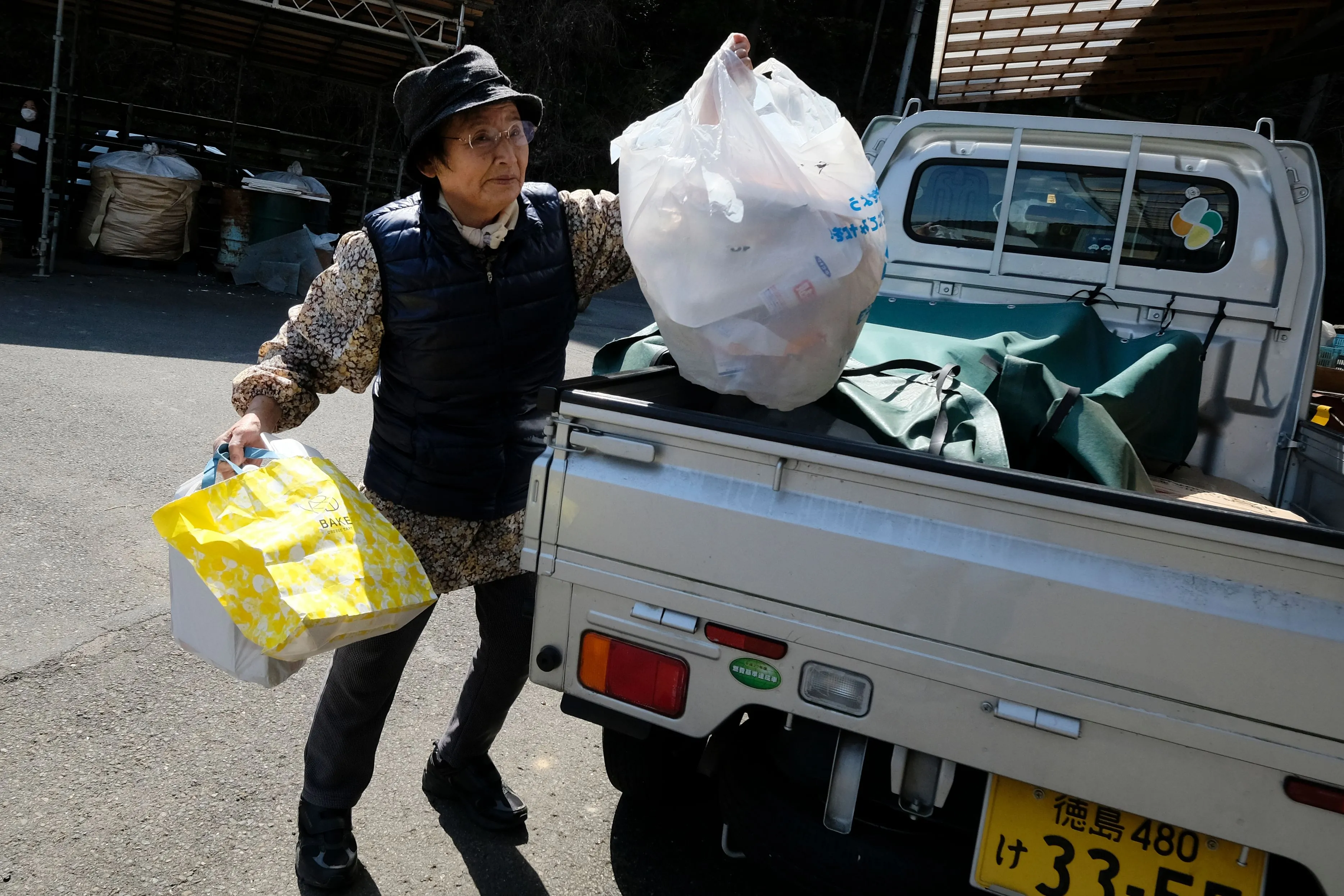 A woman bringing trash to a waste centre in the town of Kamikatsu, Tokushima prefecture.