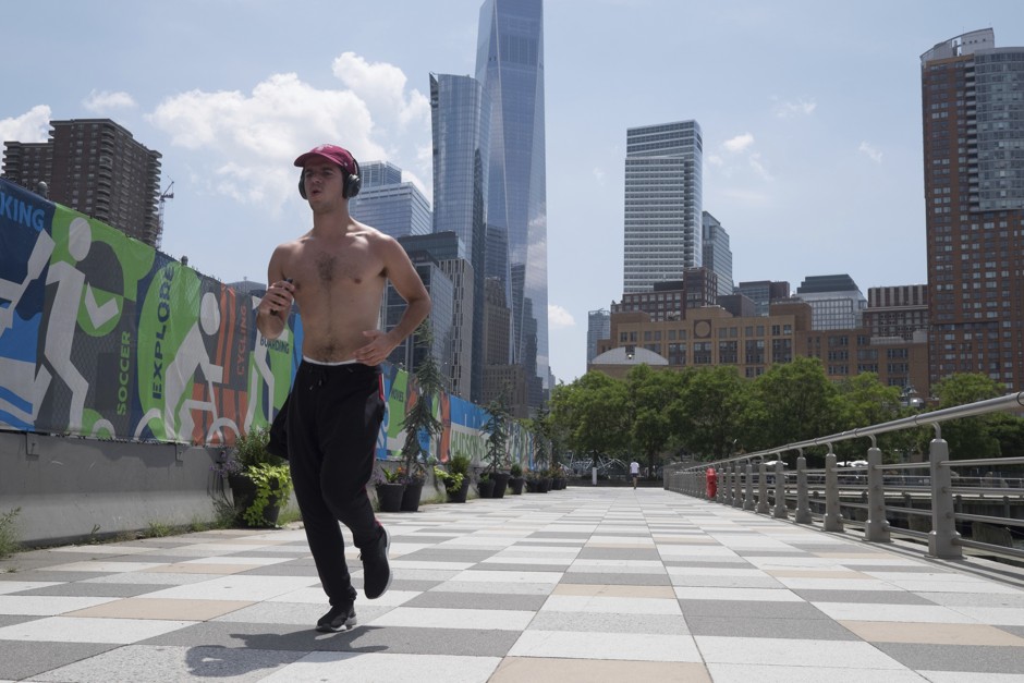 A man runs along the Hudson River Walkway in New York City during a heat wave.