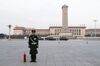 A member of the Chinese People's Armed Police stands guard next to a fire extinguisher in Tiananmen Square.