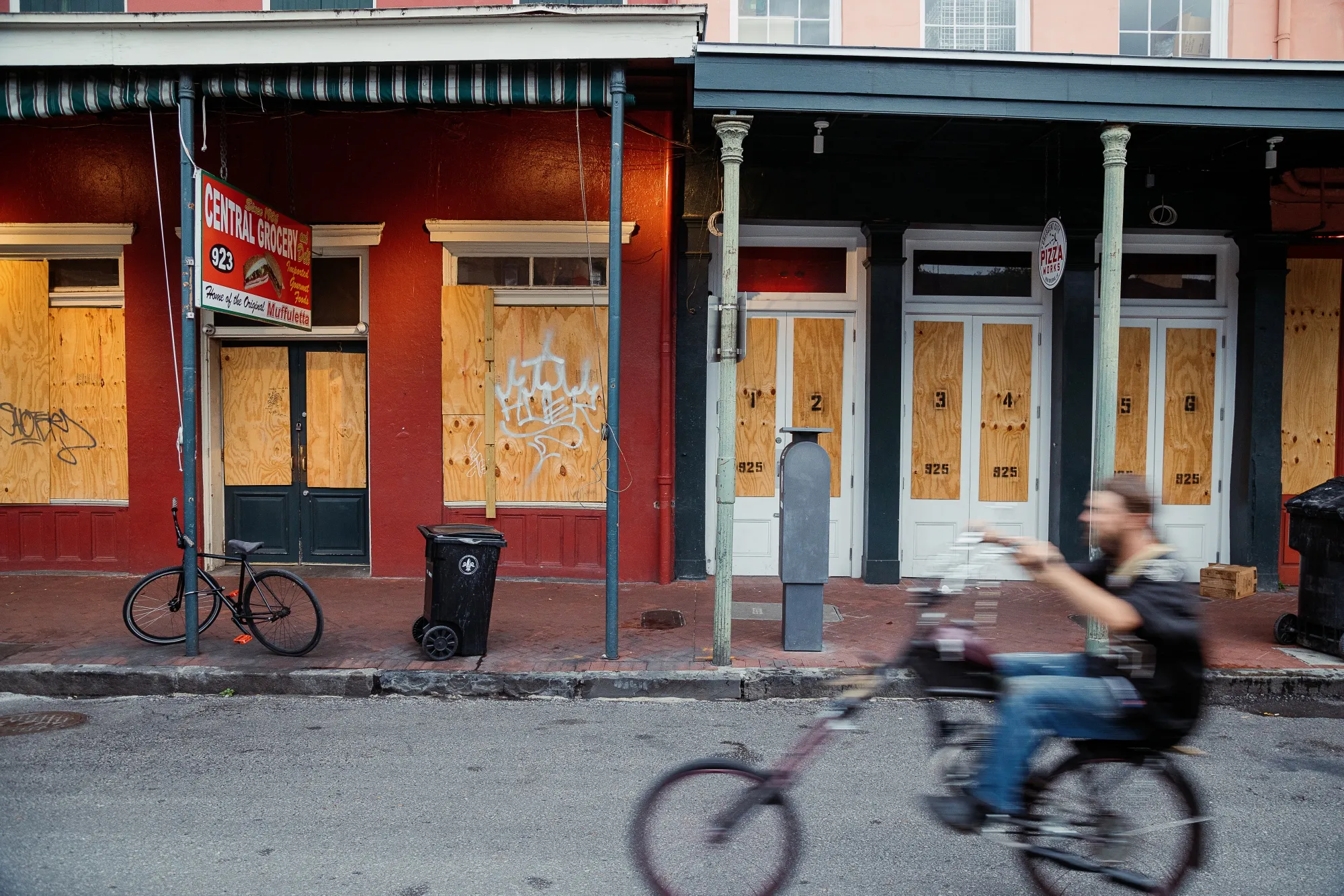 A cyclist rides past shops temporarily closed in&nbsp;New Orleans on May 16.
