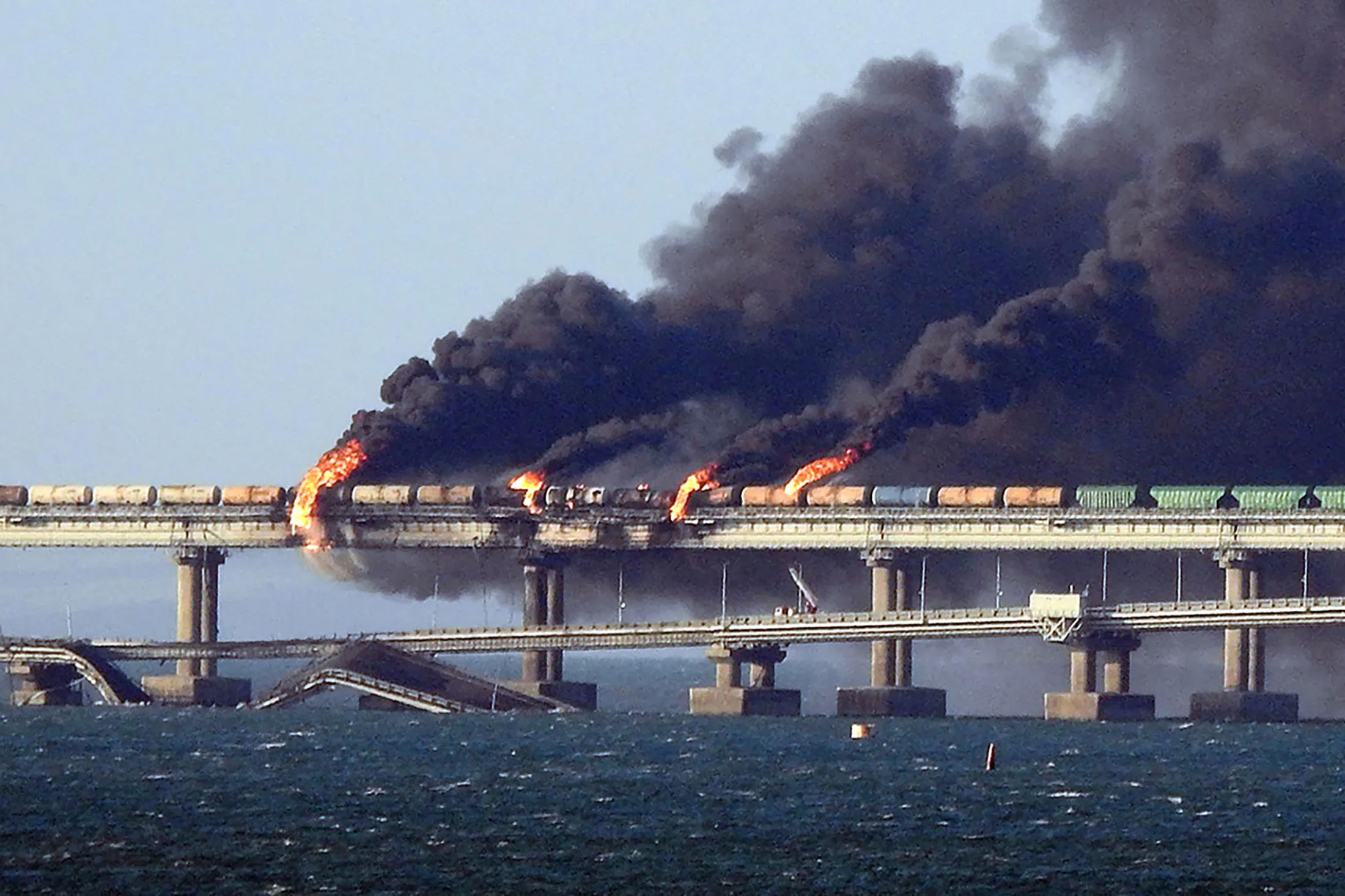 Black smoke billows from a fire on the Kerch bridge that links Crimea to Russia on Oct. 8, 2022.