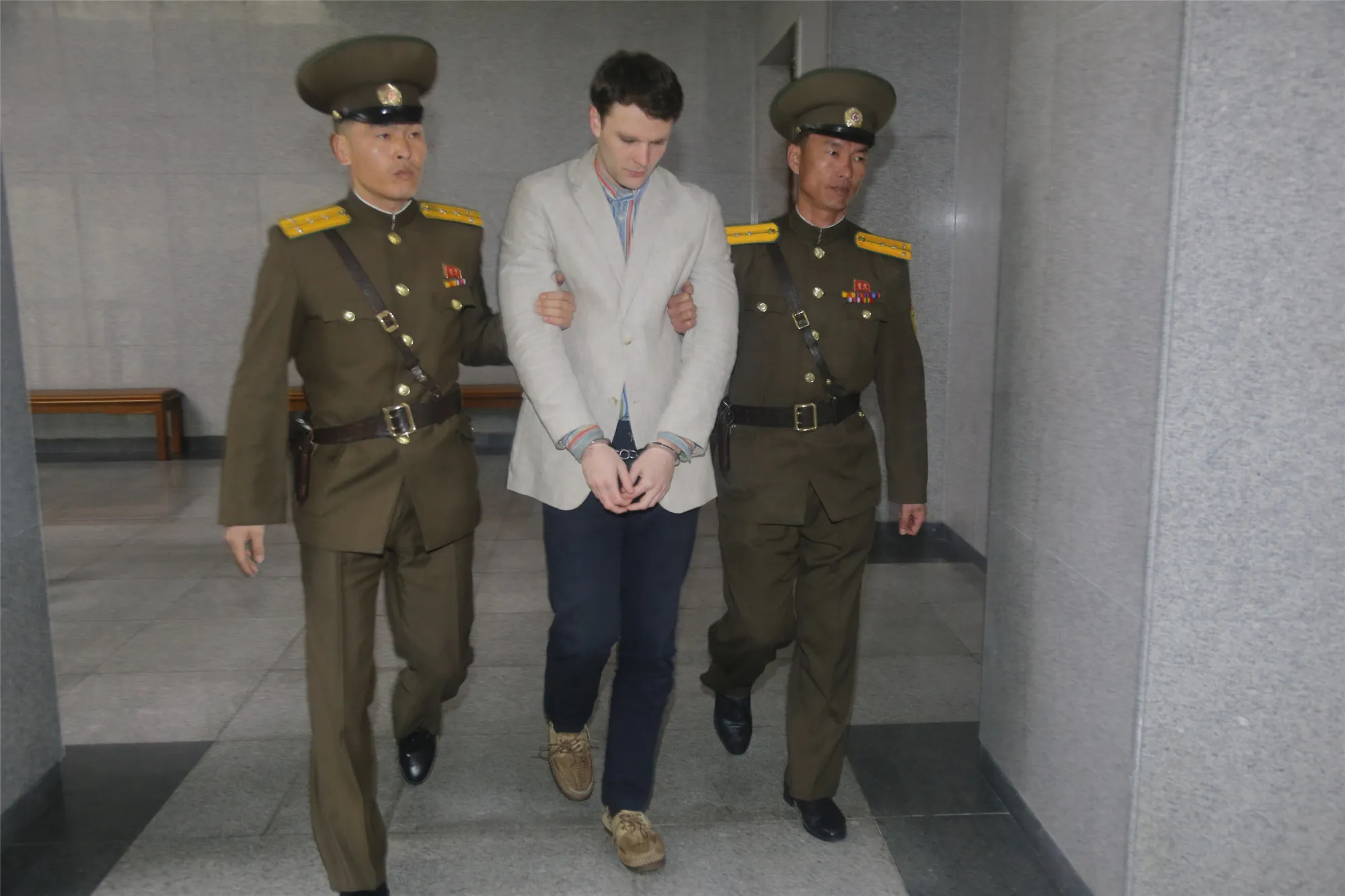 Otto Warmbier, center, arrives at a court for his trial in Pyongyang on March 16, 2015.