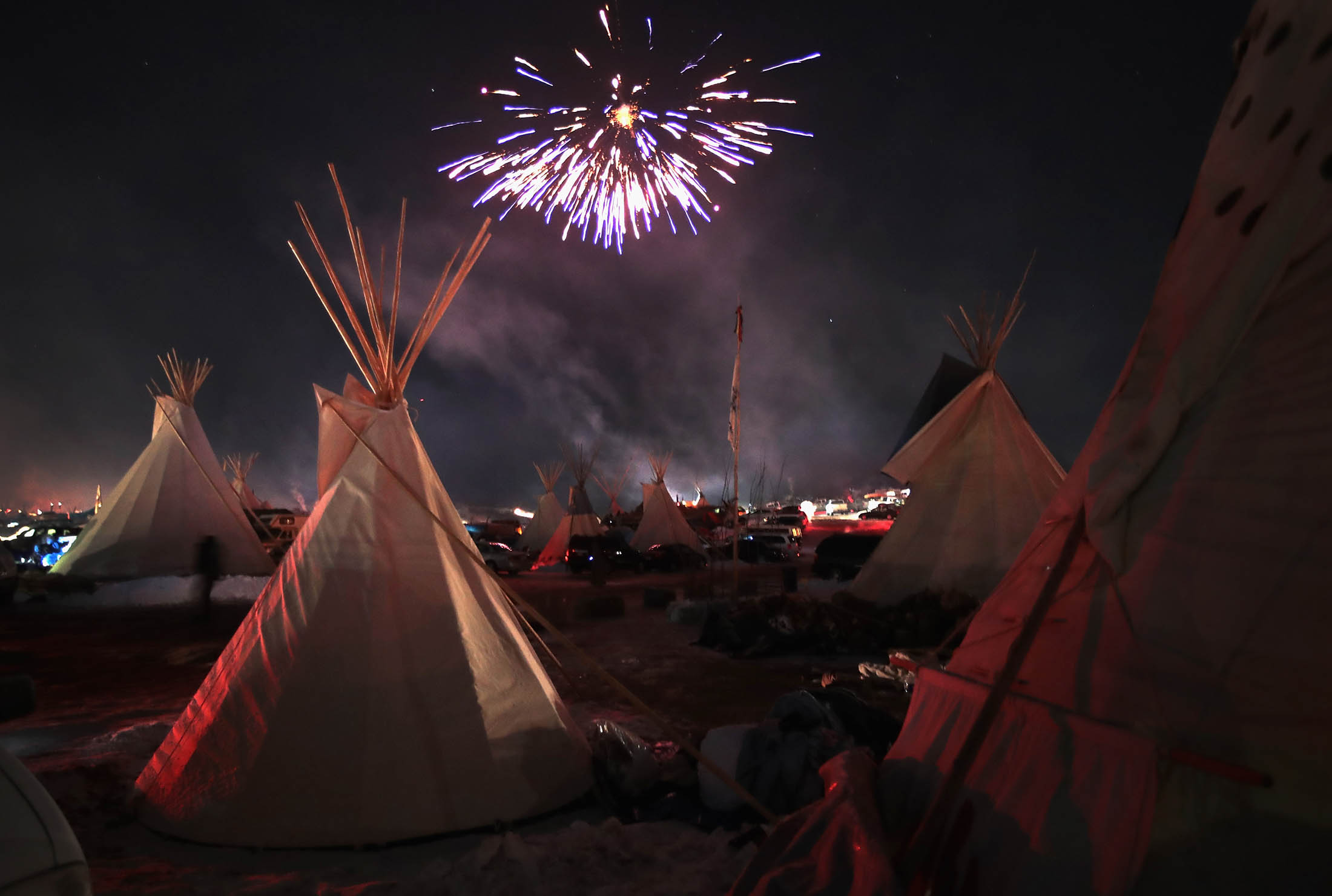 Activists celebrate with fireworks after learning an easement had been denied for the Dakota Access Pipeline on Dec. 4.
