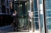 A person wearing a protective mask enters JPMorgan Chase & Co. headquarters in New York, U.S., on Monday, Sept. 21, 2020. JPMorgan CEO Dimon has made the case for a broader return, saying his firm has seen "alienation" among younger workers and that an extended stretch of working from home could bring long-term economic and social damage.