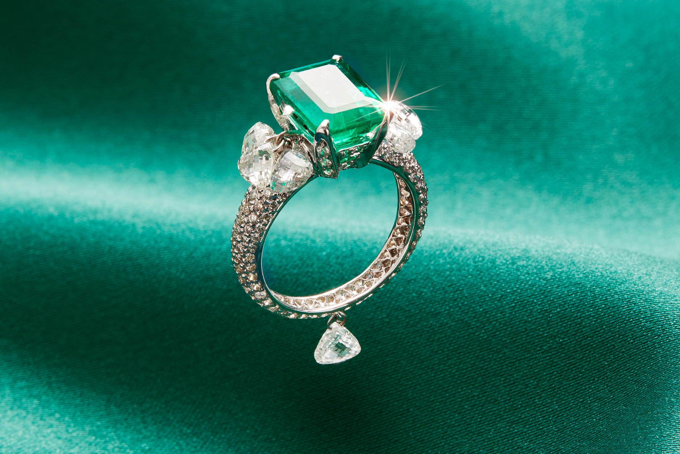 A perfect emerald green crystal ring, light reflections, on a fine wooden  table, professional product photography, best ring on Craiyon