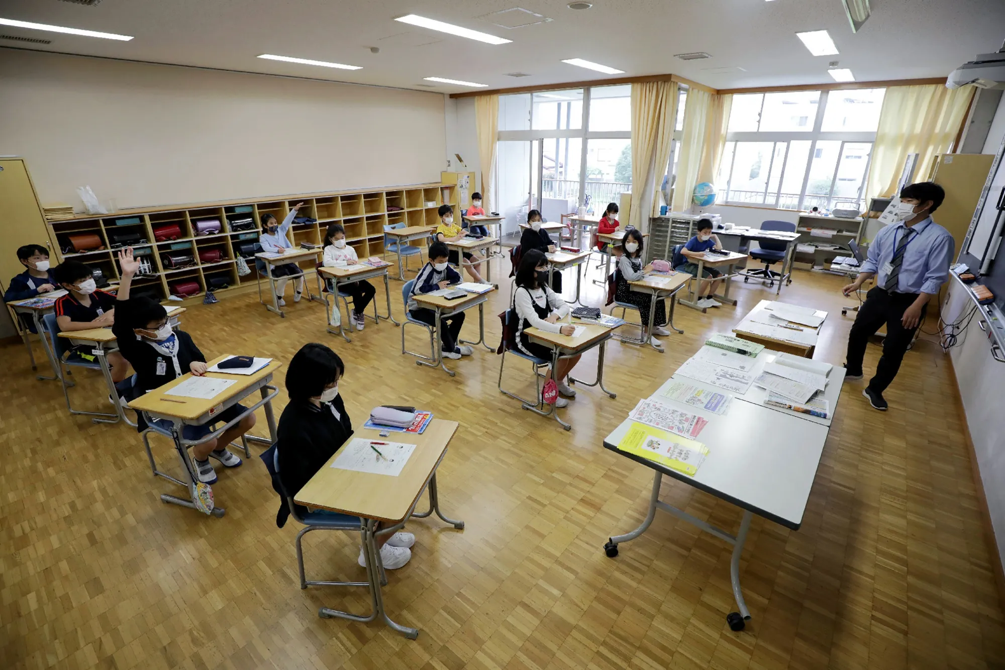 Elementary school students in Tokyo sit spaced apart for social distancing on June 1. PhotographerL Jiji Press/AFP via Getty Images