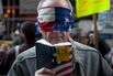 A blindfolded demonstrators holds a copy of the U.S. Constitution during a protest outside Hyatt Hotels Corp.'s Grand Hyatt at Grand Central Station, during the New York State Republican Gala in New York, on April 14, 2016.
