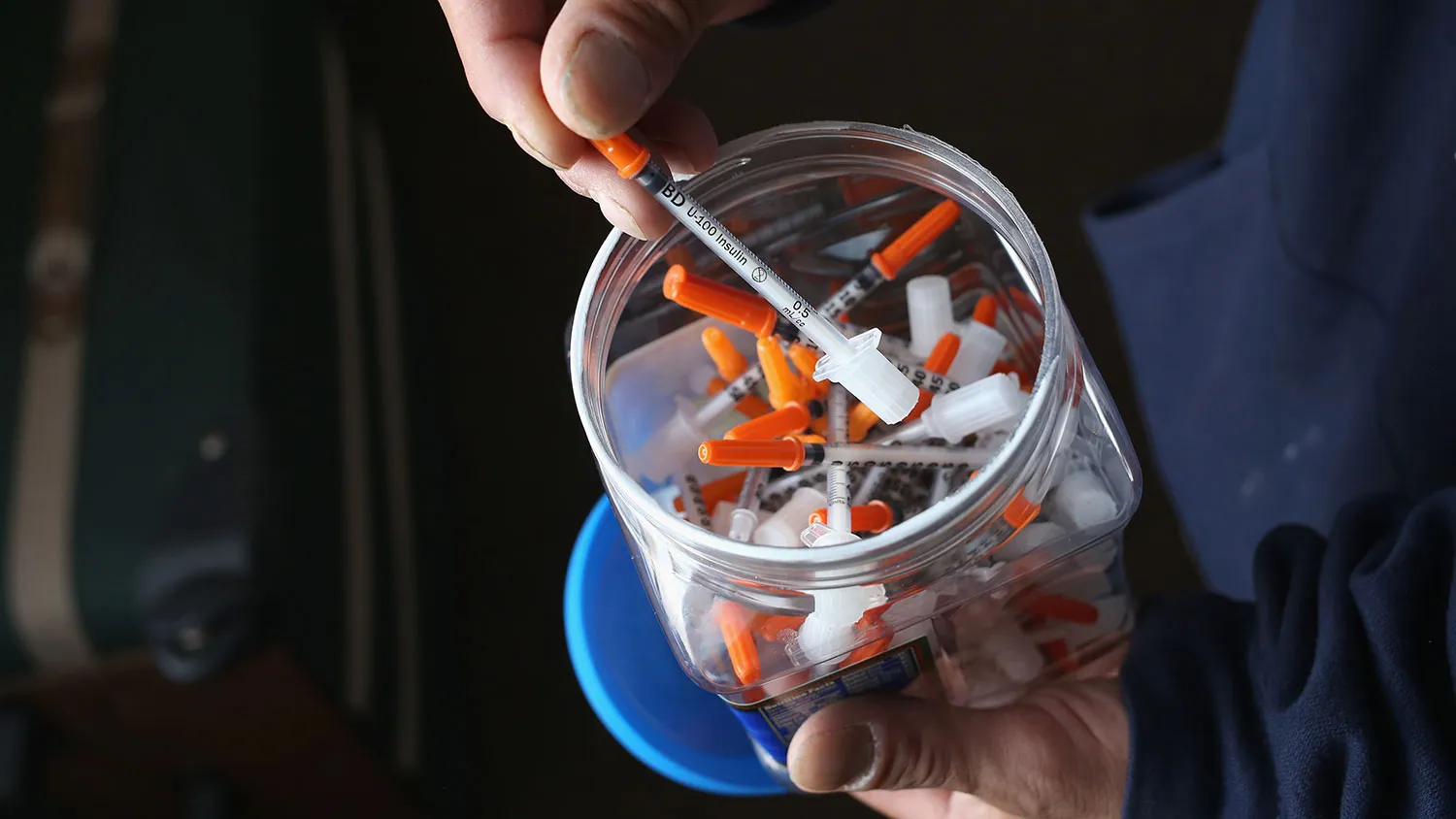 A drug user takes a needle before injecting himself with heroin on March 23, 2016, in New London, Connecticut.
