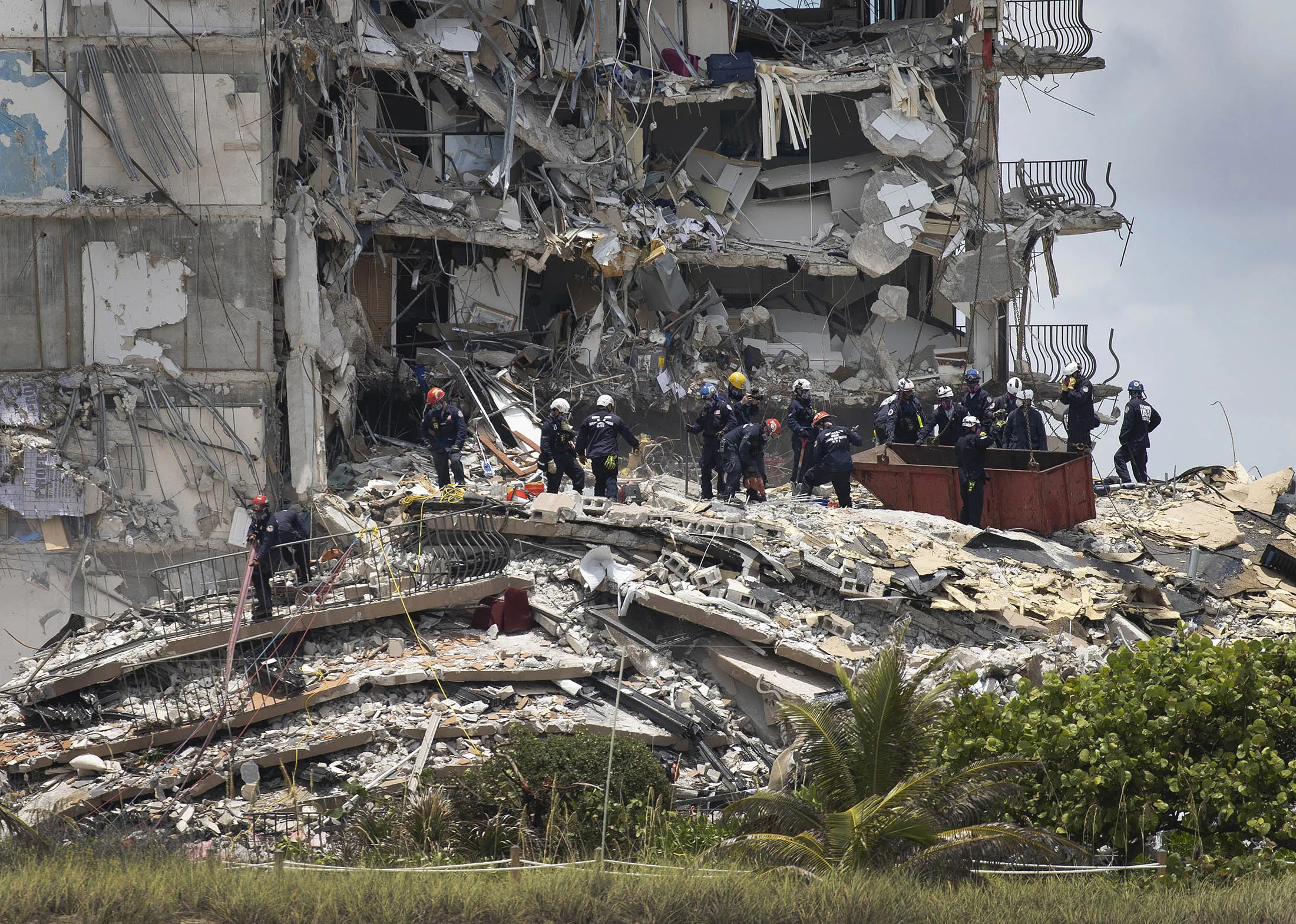 Members of the South Florida Urban Search and Rescue team look for possible survivors in the partially collapsed Champlain Towers South condo building on June 26.