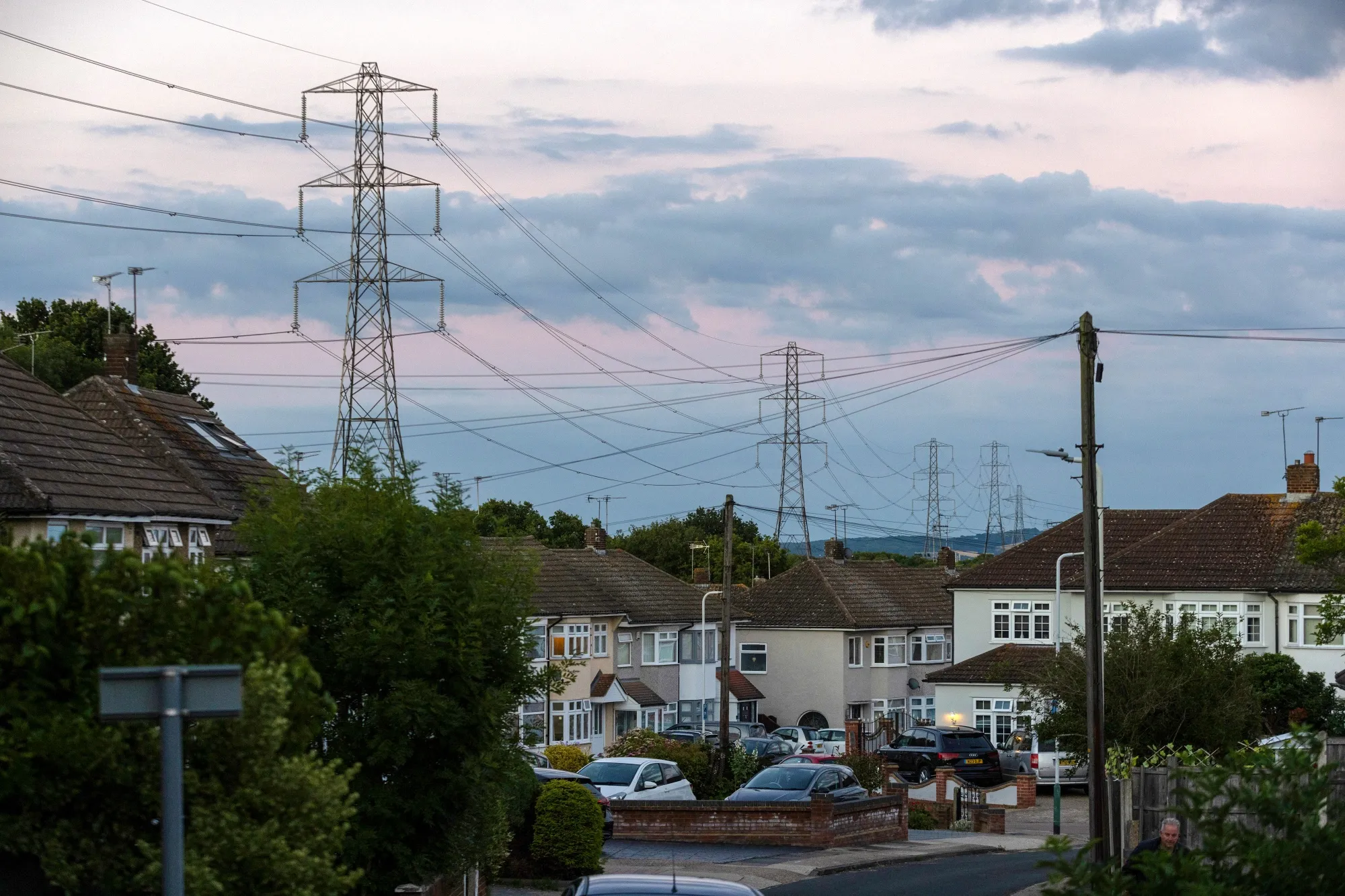 Electricity transmission towers near residential houses in Upminster, UK.