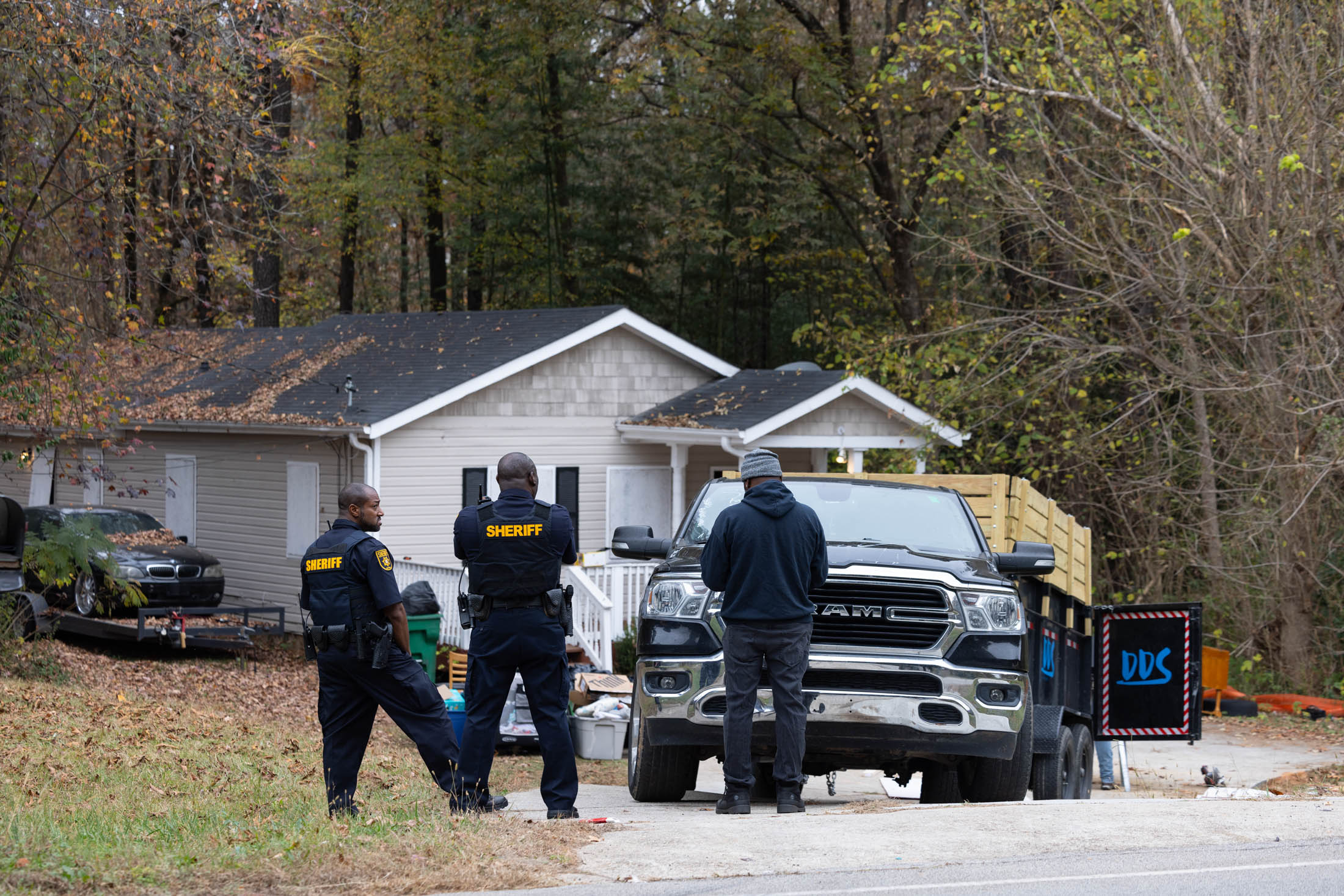 Sheriff's deputies supervise the removal of squatters’ belongings&nbsp;from a property in Ellenwood, Georgia, on Nov. 17.