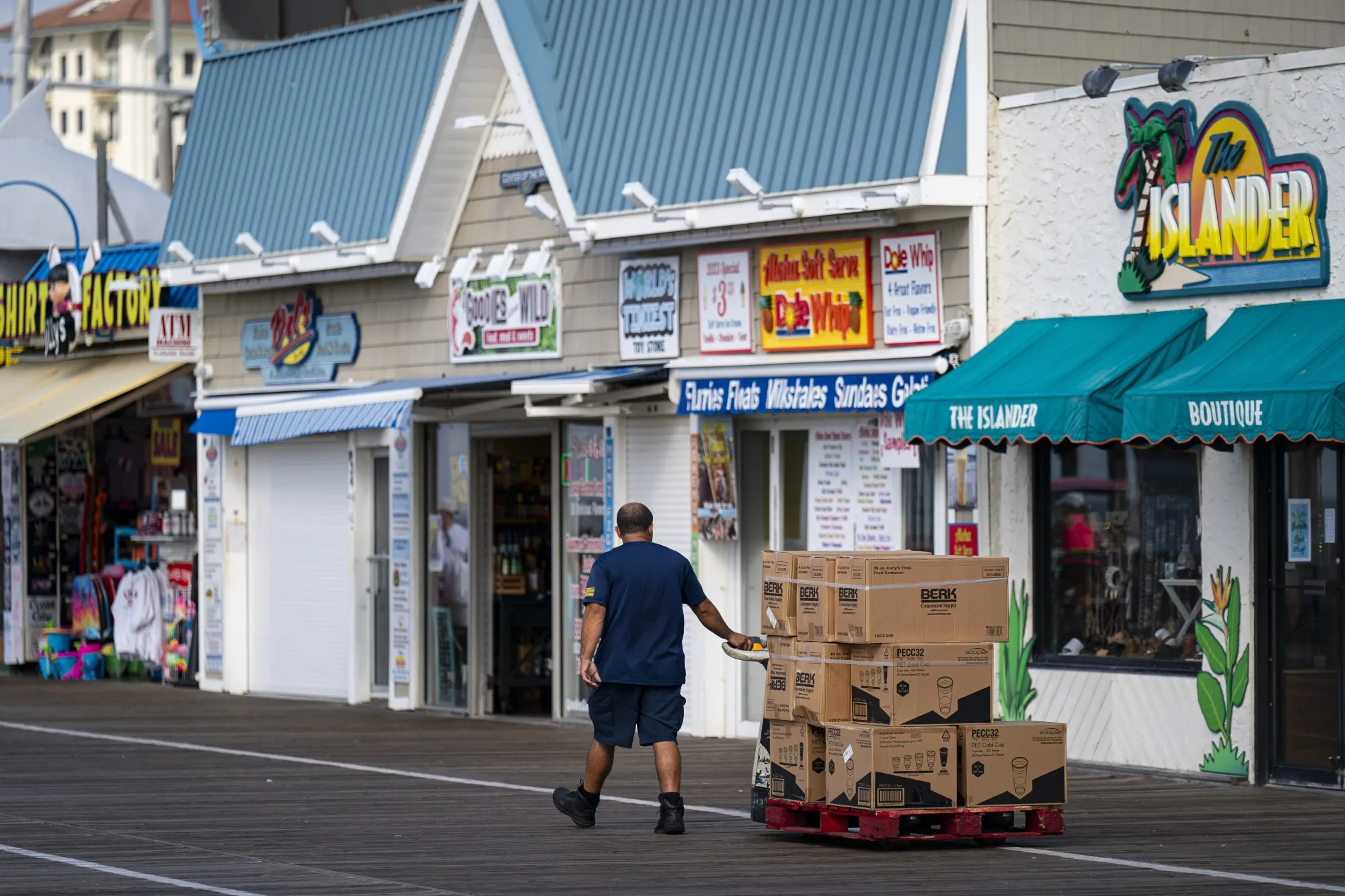 A worker makes a delivery on the boardwalk in Ocean City, New Jersey, US.