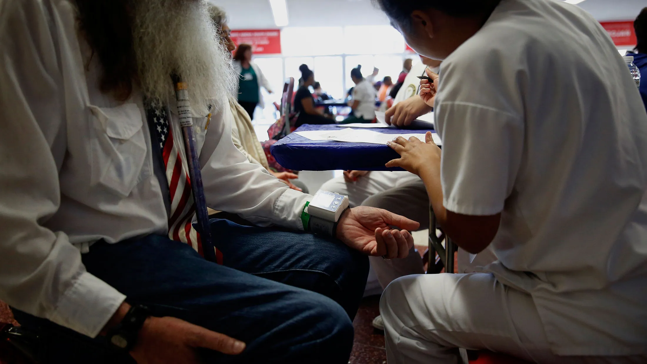 A healthcare aide checks the vitals of a patient during a clinic event in Los Angeles, California.
