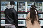 Residential properties displayed for sale in the window of an estate agents' in London.