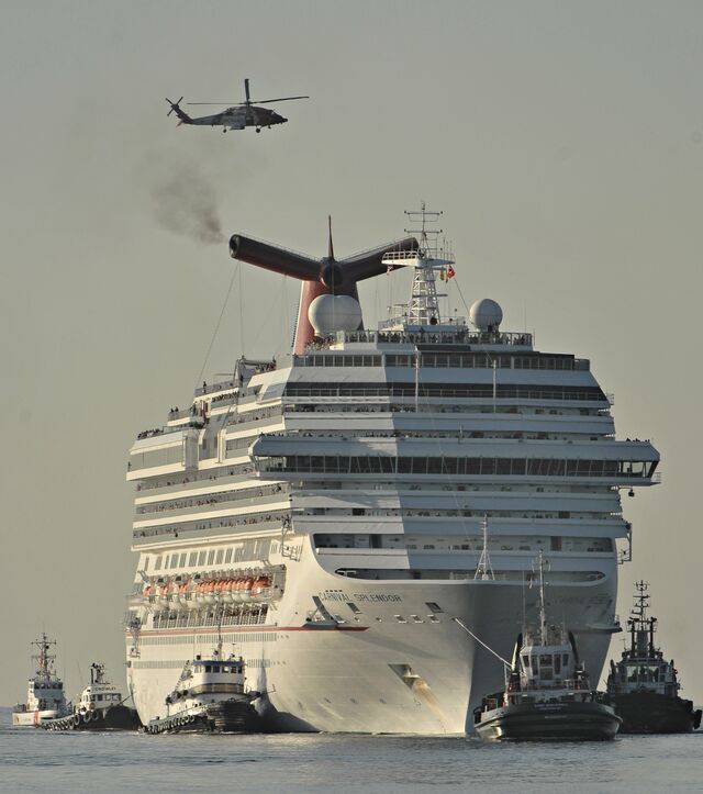 Tugboats tow the disabled <em>Carnival Splendor</em> in 2010 after the ship lost power.