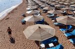 A tourist walks past sunbeds on a beach in Egypt's Red Sea resort of Sharm El-Sheikh on Nov. 10, 2015.