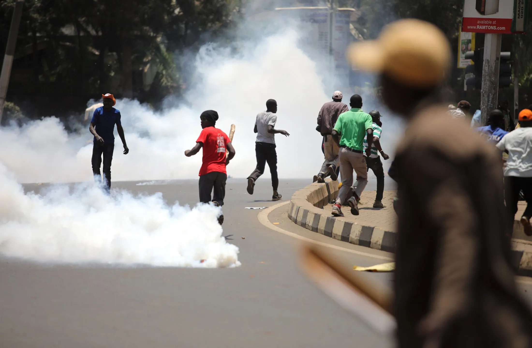 Protesters run away from tear gas in Nairobi, Kenya on Sept. 26, 2017.
