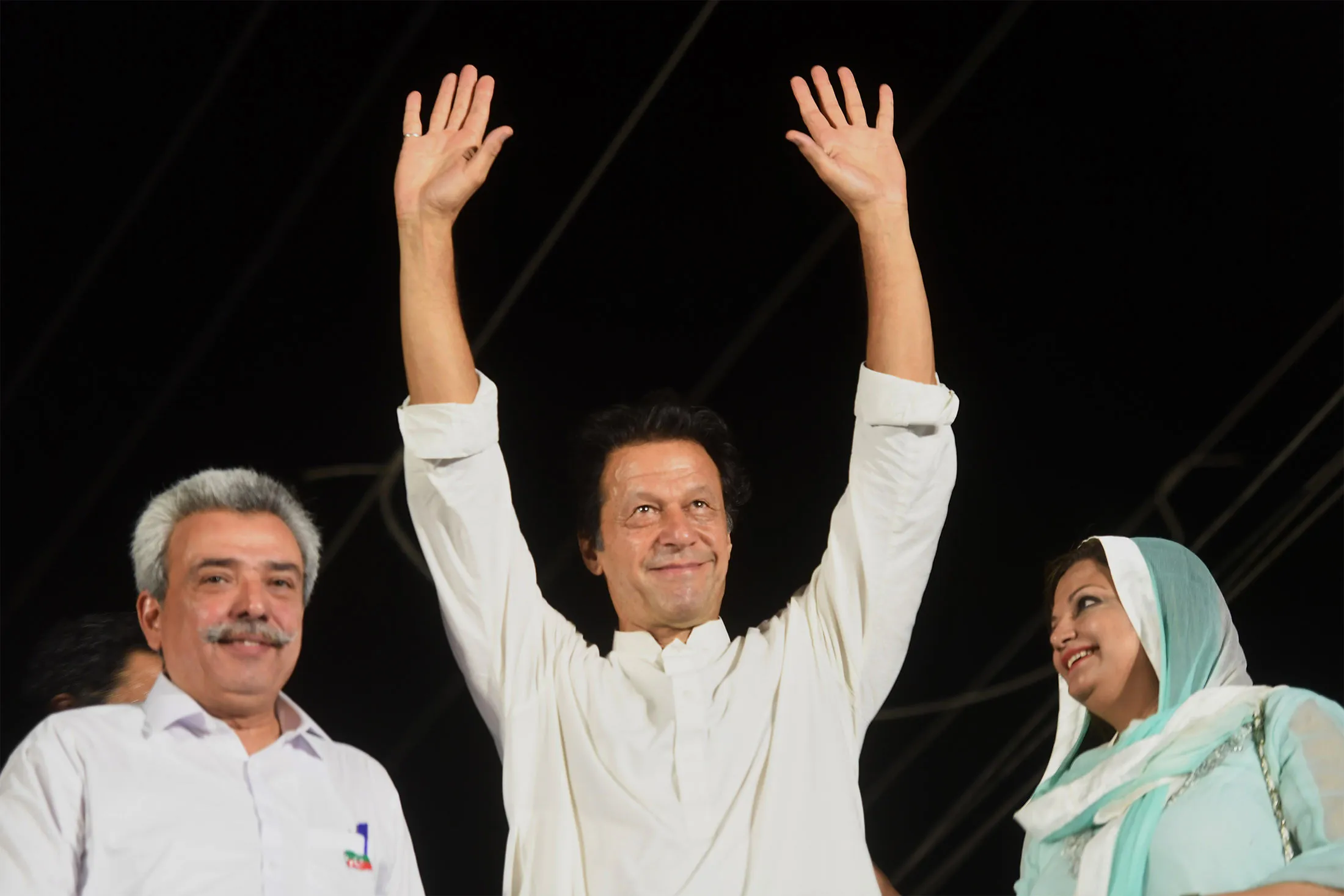 Imran Khan gestures to supporters during an election campaign rally in Karachi on July 3.&nbsp;