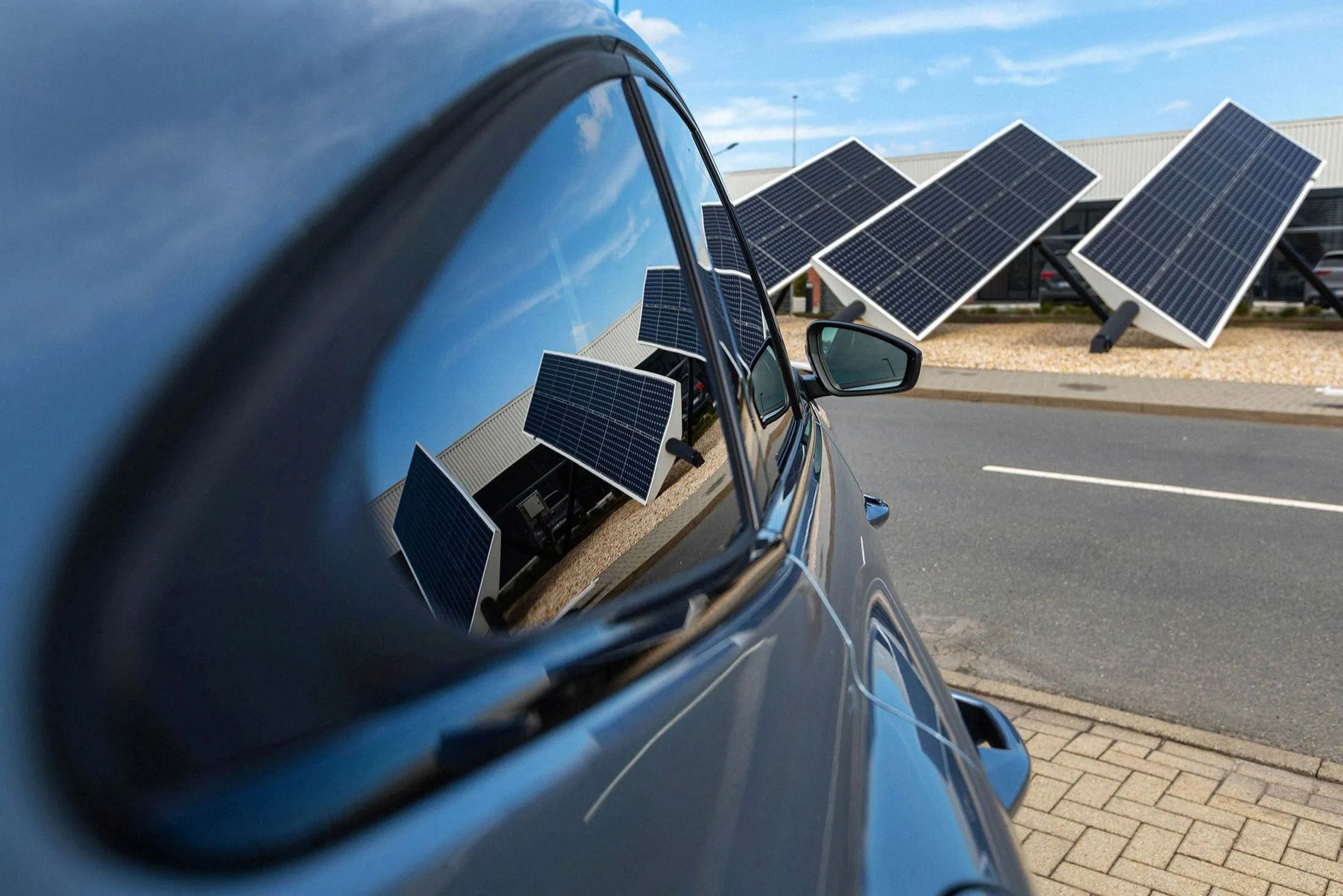 Solar panels are reflected in the windows of an electric vehicle&nbsp;at a Volkswagen&nbsp;plant.