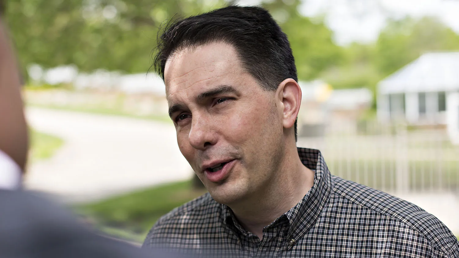 Scott Walker, governor of Wisconsin, speaks to a reporter as he arrives for the Chad Airhart Blue Jean Bash fundraiser in West Des Moines, Iowa, U.S., on Saturday, May 16, 2015. Walker declined to say whether he would participate in the Iowa Straw Poll in August if he does become a candidate.
