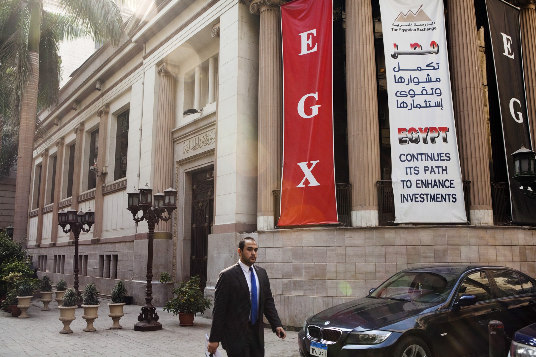 A pedestrian passes the entrance to the Egyptian stock exchange in Cairo, Egypt.