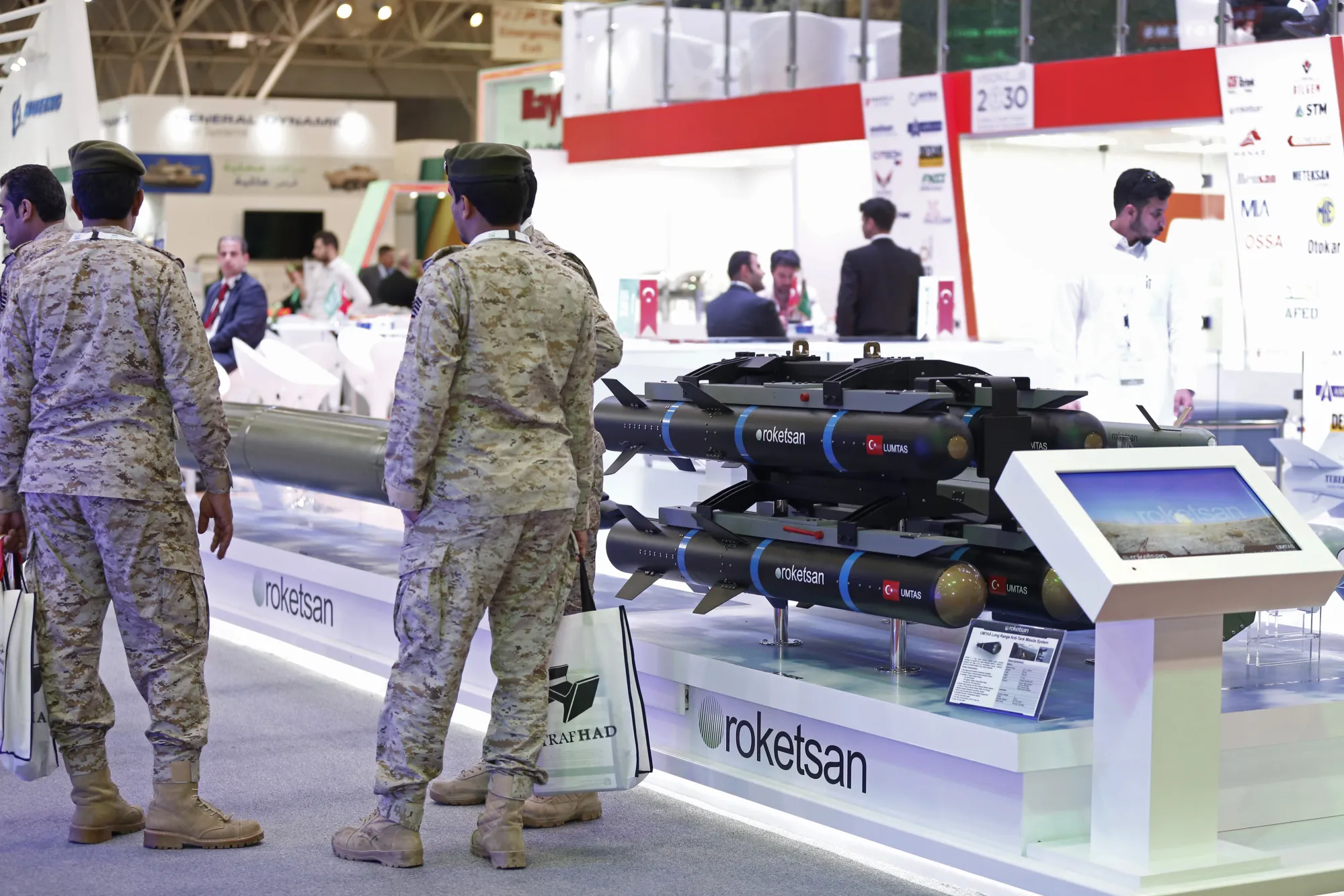 Soldiers stand beside a missile display at the Armed Forces Exhibition for Diversity of Requirements and Capabilities (AFED) in Riyadh on Feb. 27.