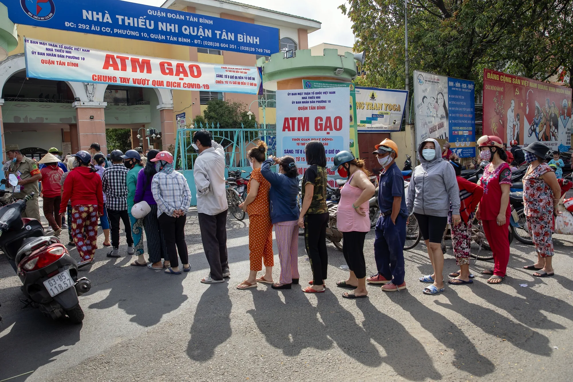 People&nbsp;stand in line to collect rice from "Rice ATM" machines at a rice distribution center in Ho Chi Minh City, Vietnam, in April.