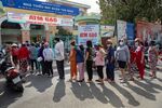 People&nbsp;stand in line to collect rice from &quot;Rice ATM&quot; machines at a rice distribution center in Ho Chi Minh City, Vietnam, in April.
