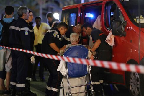 Rescue workers help an injured woman to an ambulance on July 15.