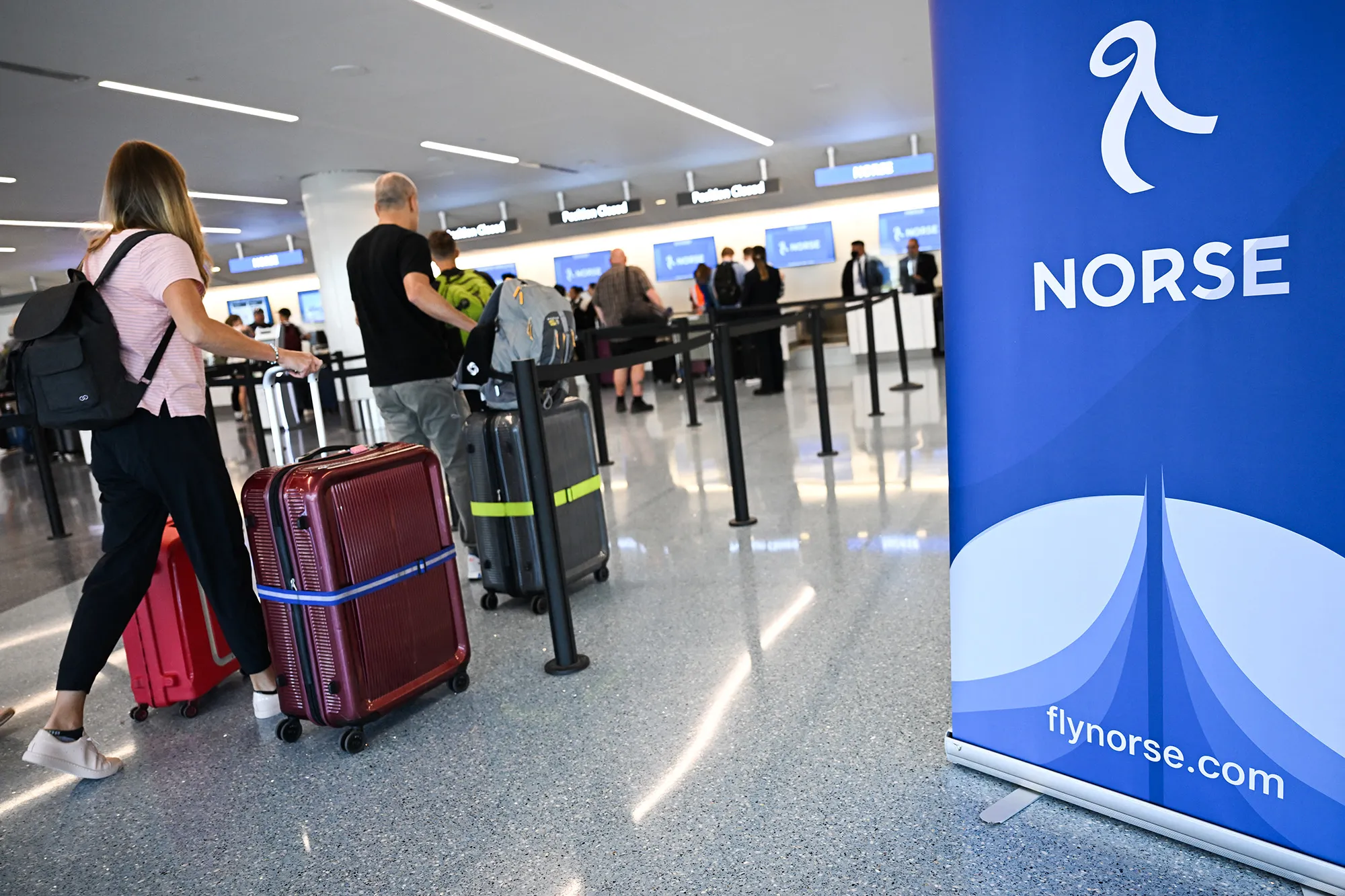 Passengers check in for a Norse Atlantic flight at Los Angeles International Airport.