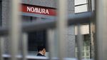 A pedestrian walks past a Nomura Securities Co. branch, a unit of Nomura Holdings Inc., in Tokyo, Japan, on Monday, April 27, 2015. Nomura, Japan's largest brokerage, is scheduled to report fourth-quarter earnings on April 30.
