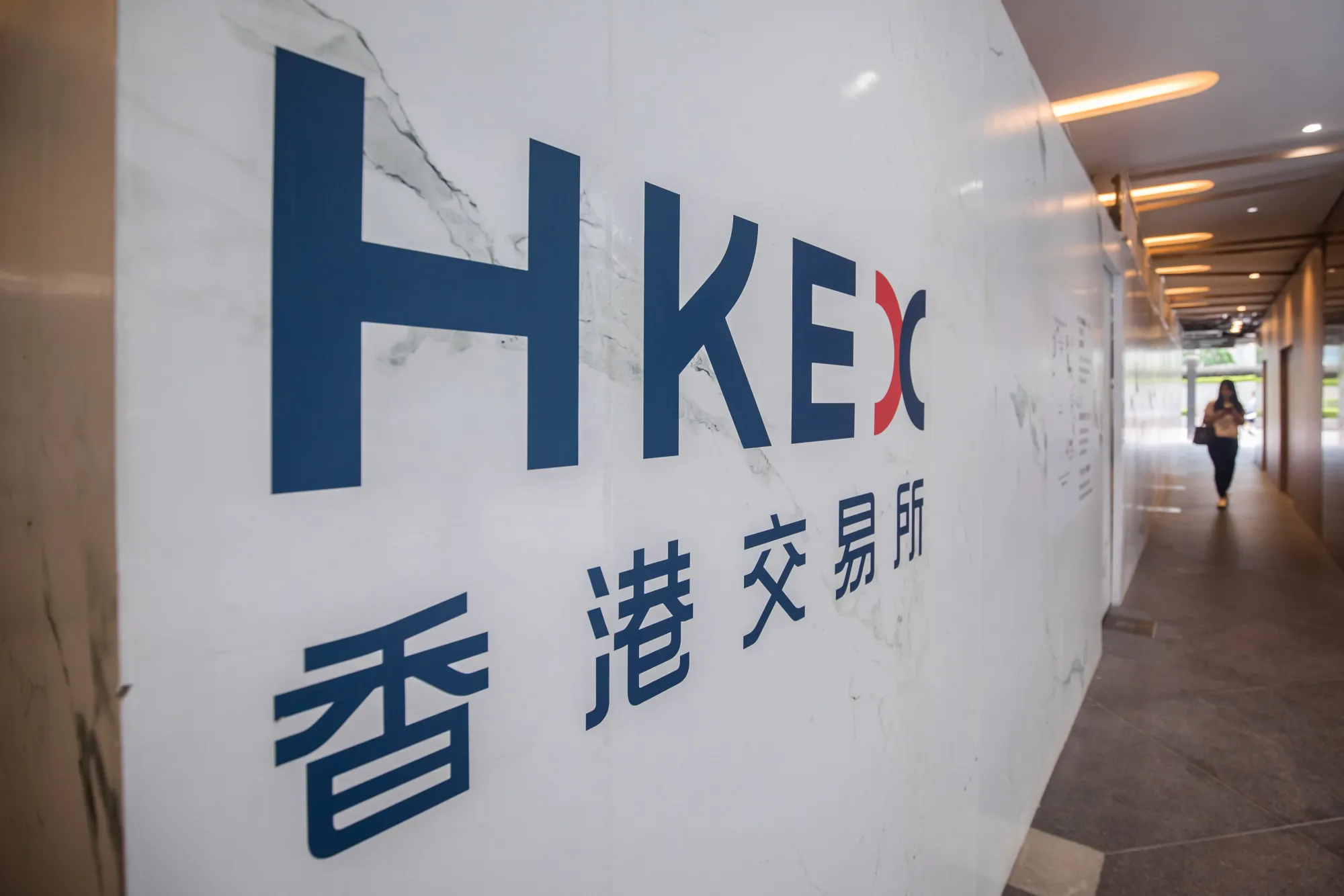 Signage for Hong Kong Exchanges & Clearing Ltd. (HKEx) is displayed at the Exchange Square complex in Hong Kong, China, on Wednesday, Aug. 9, 2017. HKEx, Asia's largest bourse operator by market value, said second-quarter profit was HK$1.78 billion ($230 million), a 14 percent increase from HK$1.55 billion a year earlier.