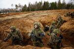 Estonian soldiers defend a dug-in position during a NATO exercise, in the Tapa central military training area in Estonia, April 14, 2022.