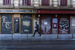 A pedestrian walks past a closed bars and restaurants in Madrid.