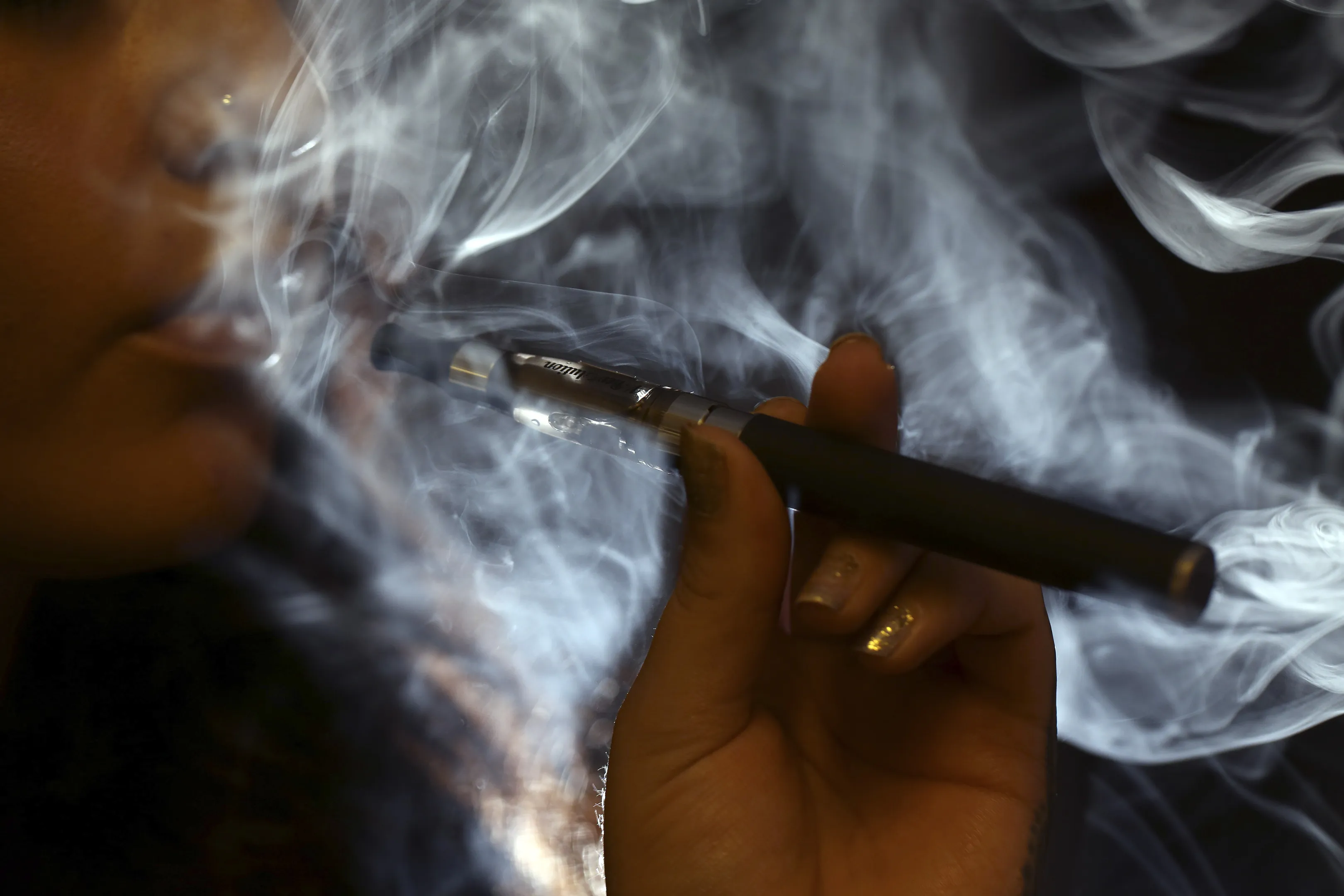 A woman smoking an e-cigarette.