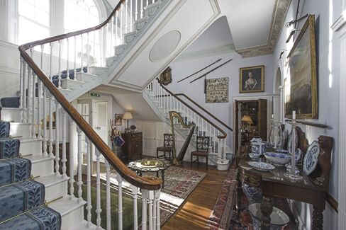 Seen here, the castle’s “double flying staircase” with a Venetian window that overlooks the garden.