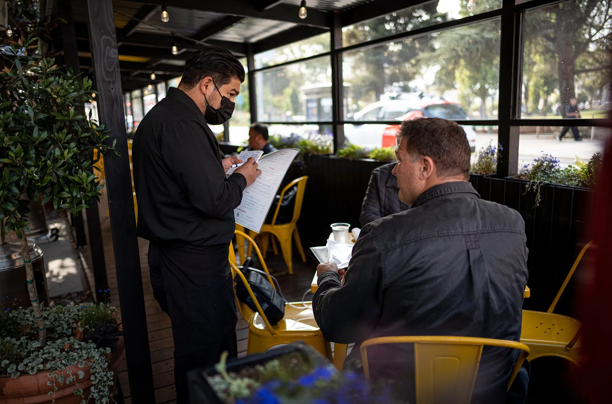 A server takes an order from a customer at a restaurant&nbsp;in San Francisco, California.