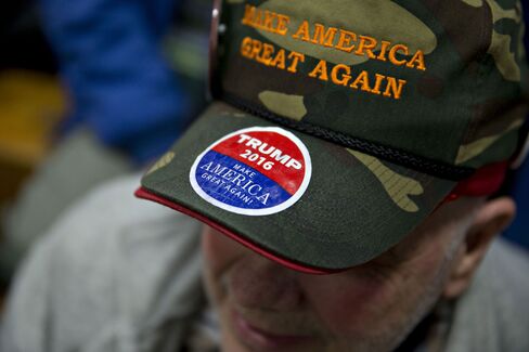 Attendee Rich Travers wears a “Make America Great Again” hat as he waits for Trump to speak.