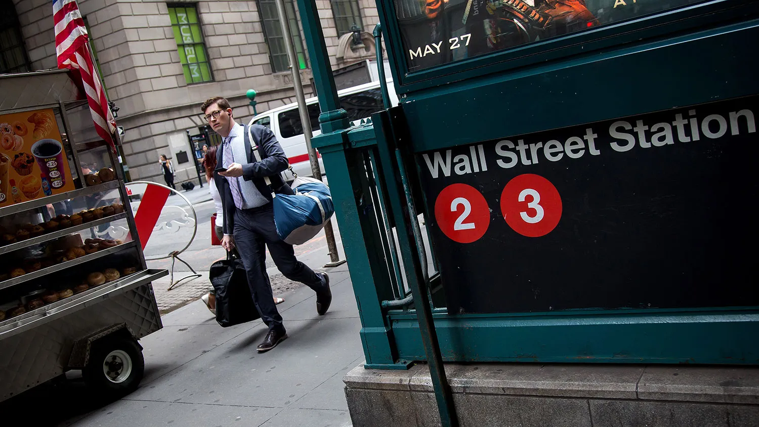 A pedestrian walks past the Wall Street subway station in New York on May 27, 2016.
