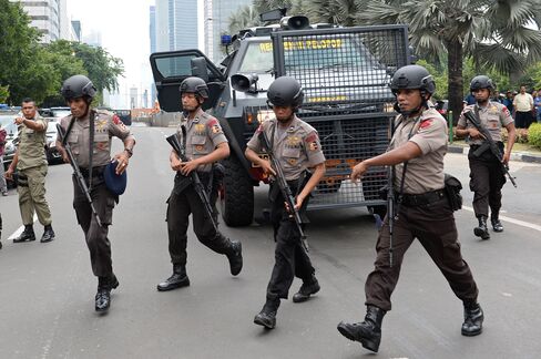 Armed police officers secure the blast site.