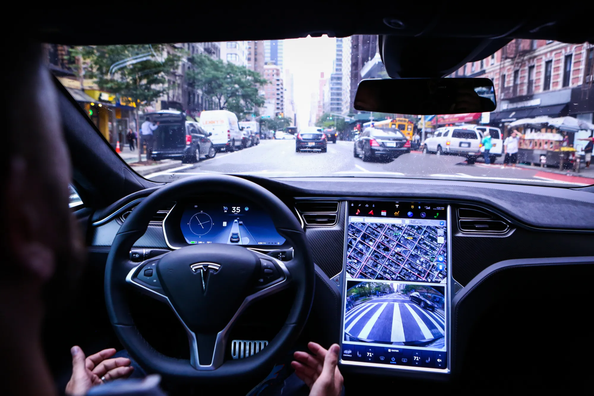 A driver rides hands-free in a Tesla Motors Inc. Model S vehicle equipped with Autopilot hardware and software in New York