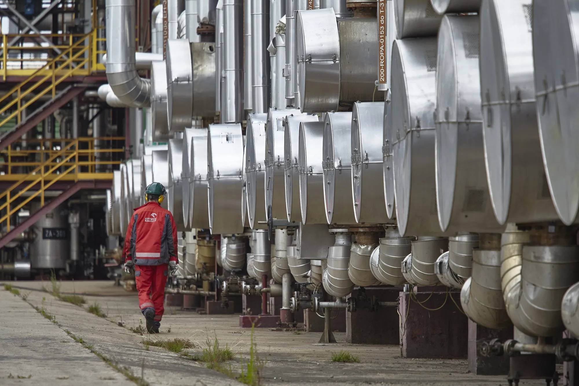 An employee examines pipework at a PKN Orlen SA oil refinery in Plock, Poland.&nbsp;