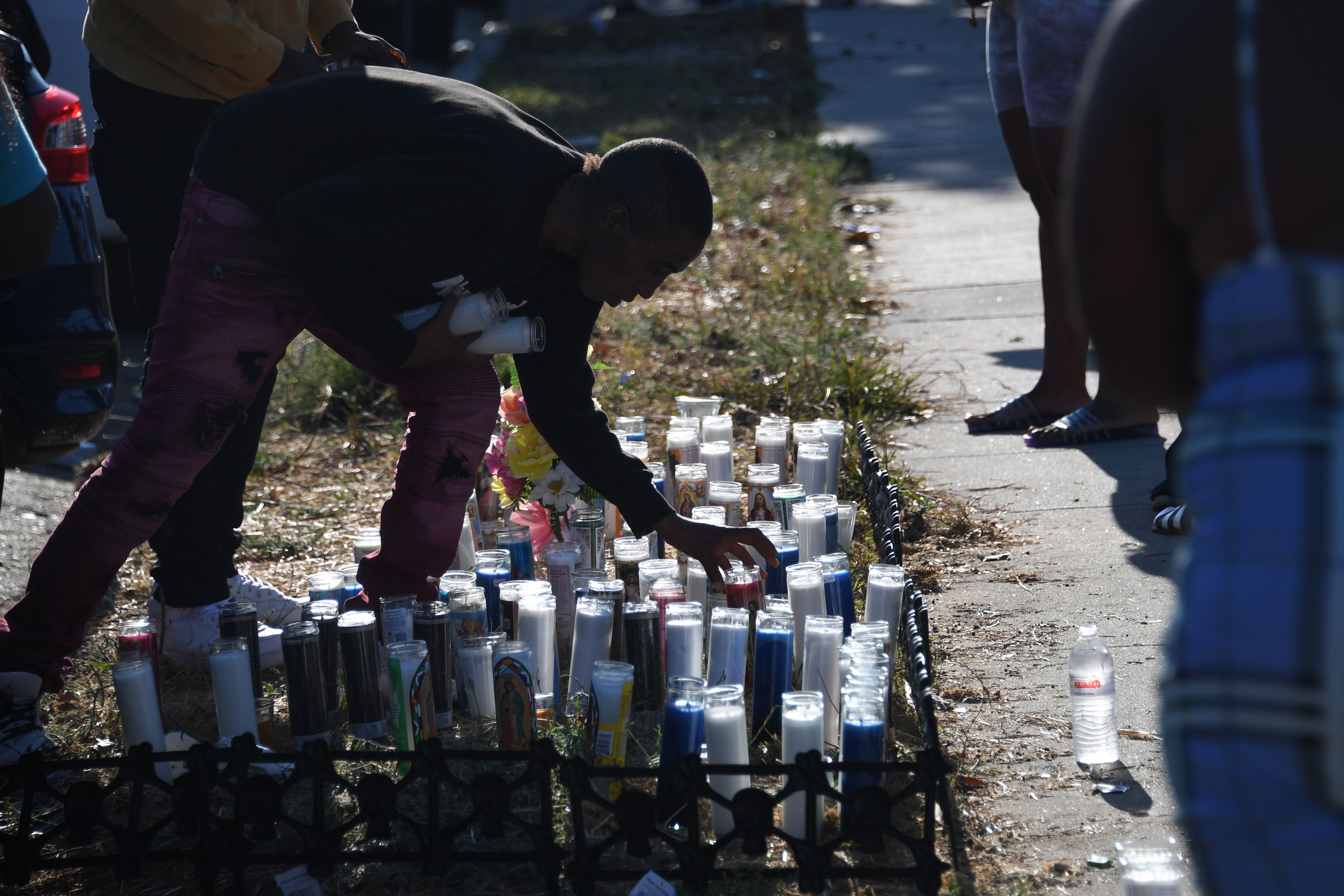 A man places candles at a makeshift memorial&nbsp;in Los Angeles&nbsp;at the location where Dijon Kizzee was shot and killed on Aug.&nbsp;31 by Los Angeles Sheriff's deputies.&nbsp;